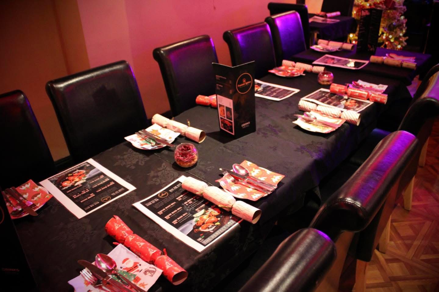 Christmas table set with crackers and festive menus at Fusion Spice