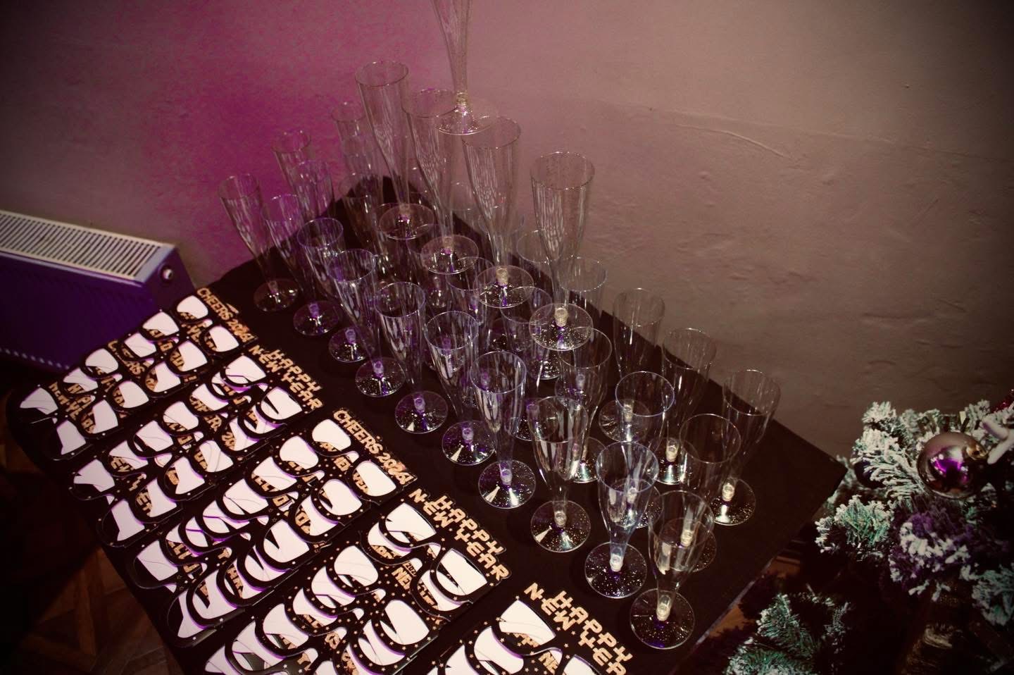 Champagne flutes and Happy New Year party glasses on the table