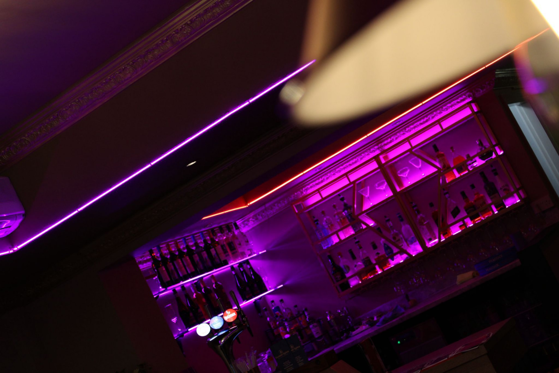 Neon strip lighting above the bar