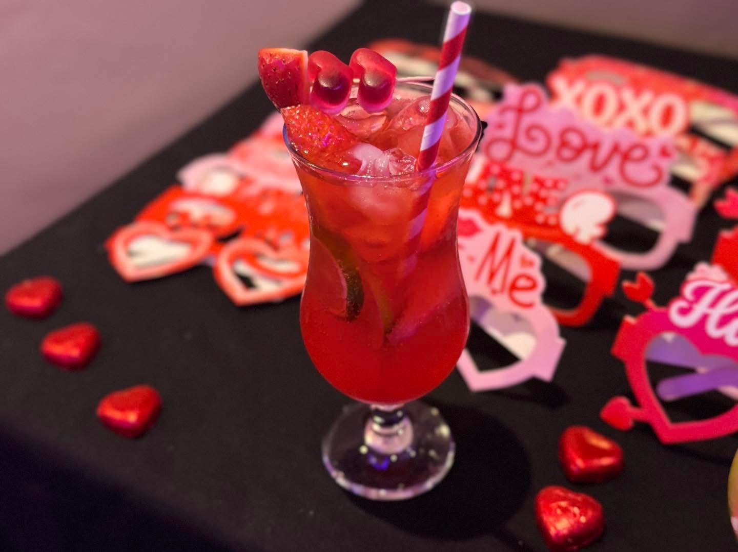 Red Valentine's cocktail with heart decorations at Fusion Spice