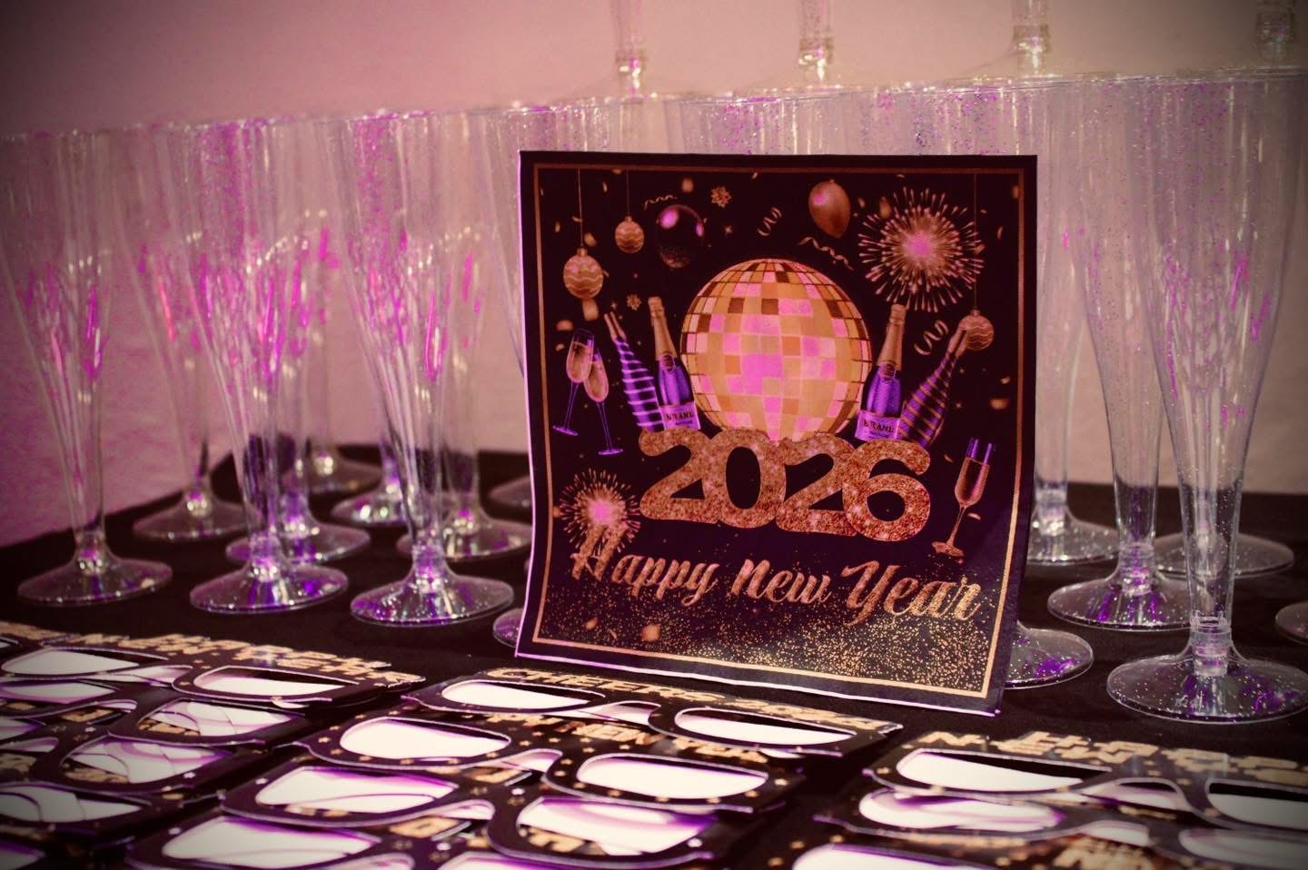 Happy New Year 2026 sign with champagne flutes at Fusion Spice