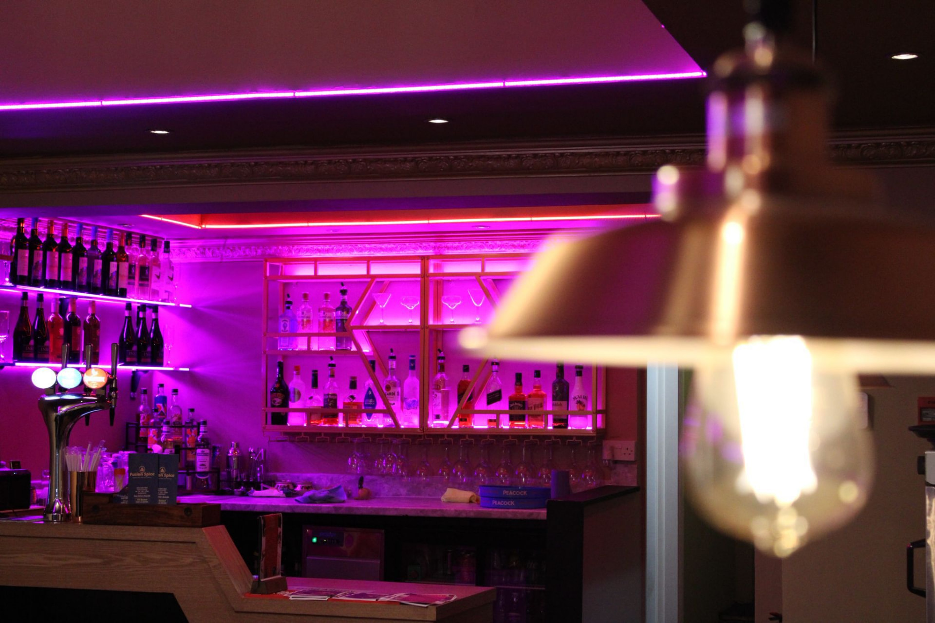 Copper pendant light beside the bar